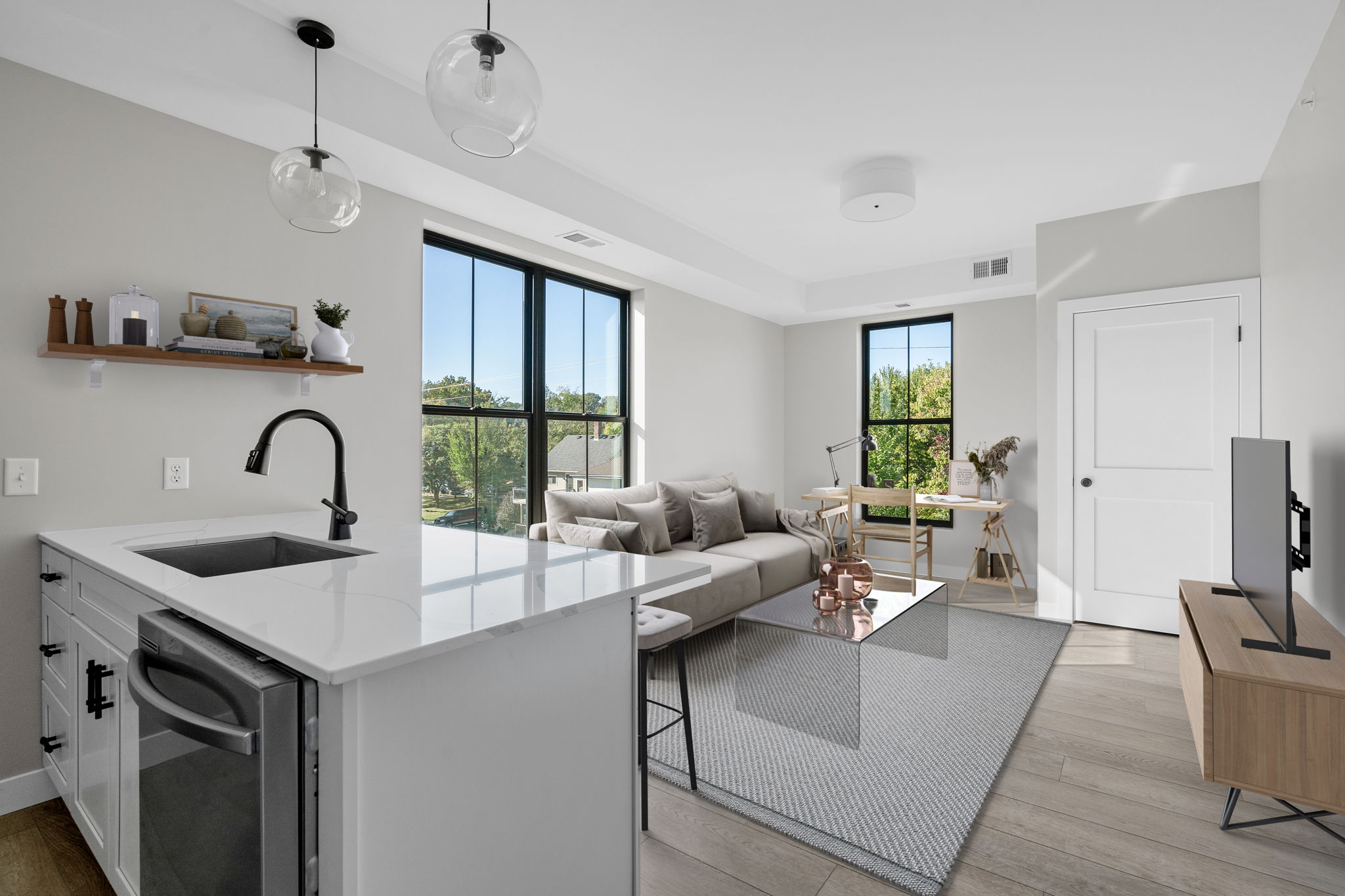 a modern kitchen and living room with a large window at Fuller Park Flats